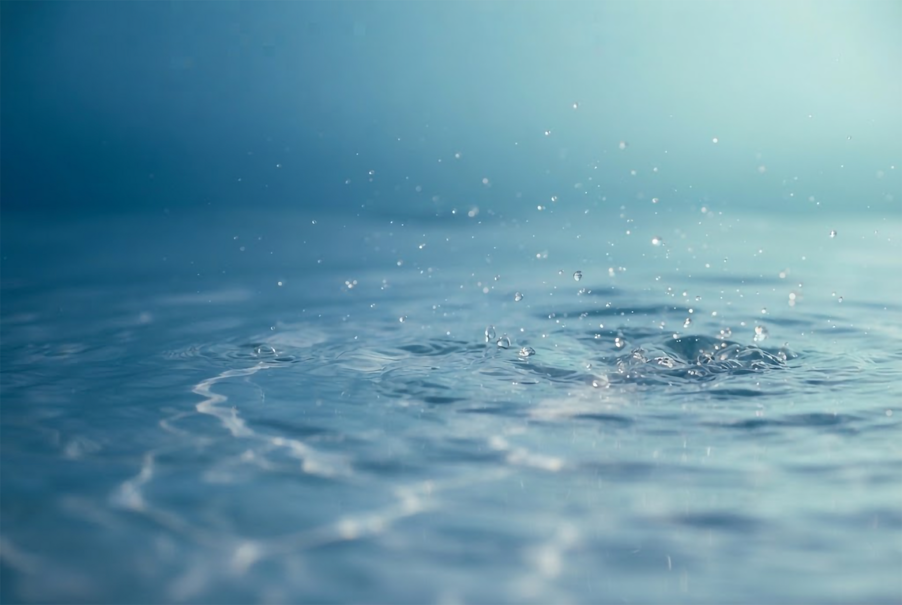 Calm water surface with gentle ripples in cool blue morning light