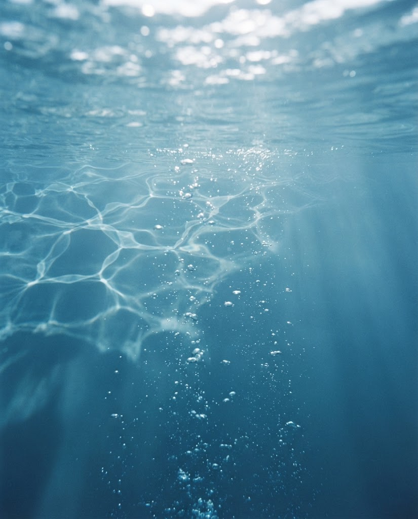 Sunlight refracting through blue water just beneath the surface